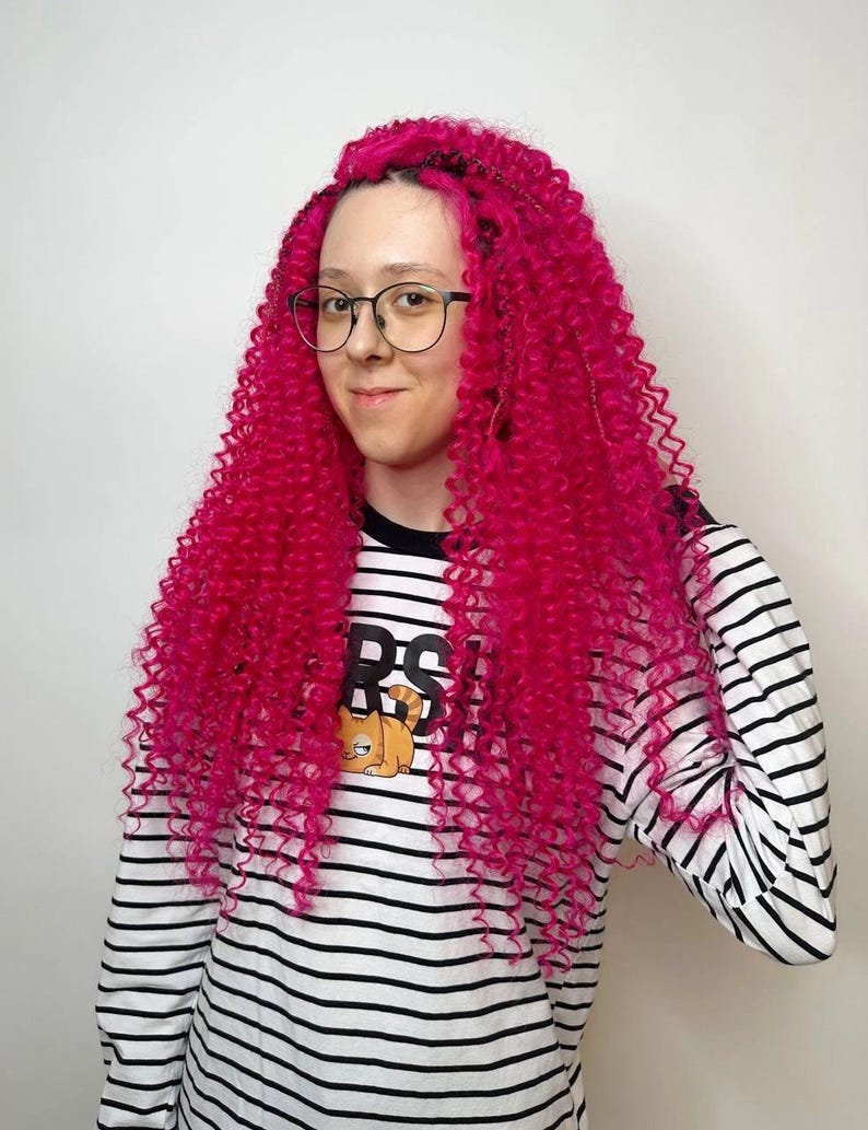 Model wearing bright pink curly DE hair extensions festival style