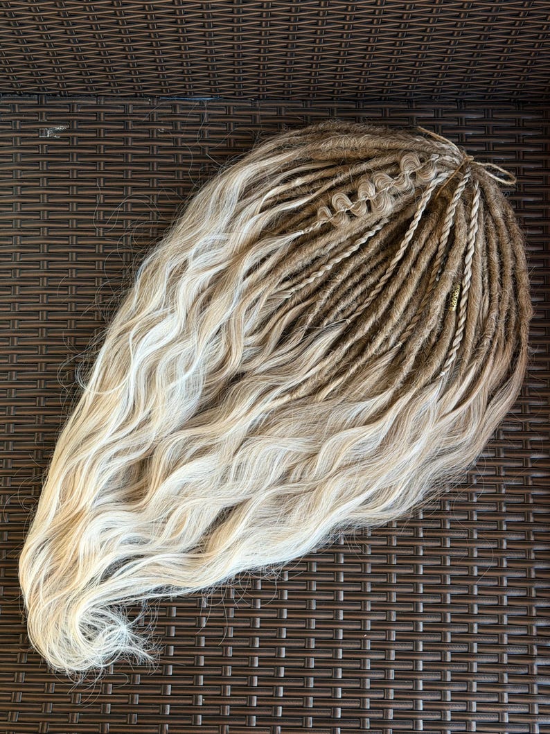 Blonde DE dreadlock set held by hand showing length texture and natural soft waves