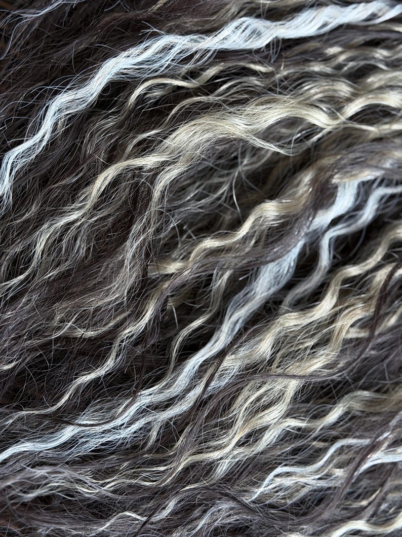 Close up of handmade synthetic dreadlocks featuring silver gray, ash blonde and brown boho curls