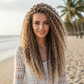 Close-up portrait of woman on beach with curly blonde brown handmade dreadlock extensions