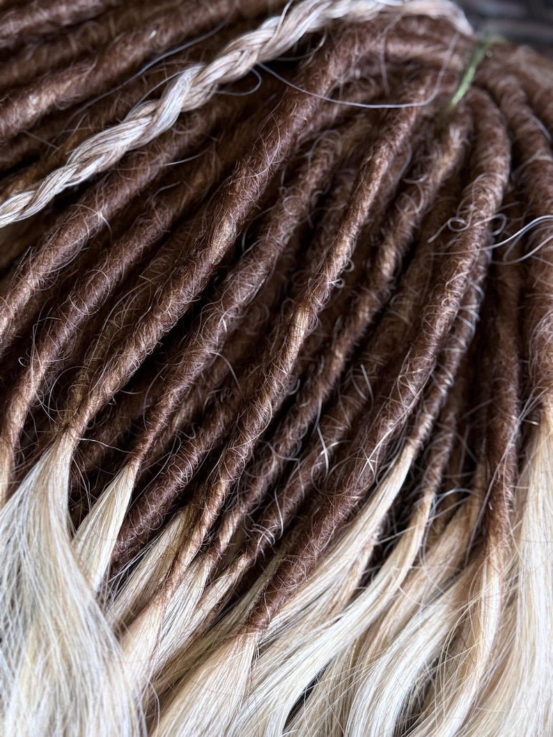 Close up of handmade chocolate brown dreadlocks with blonde ends and natural texture